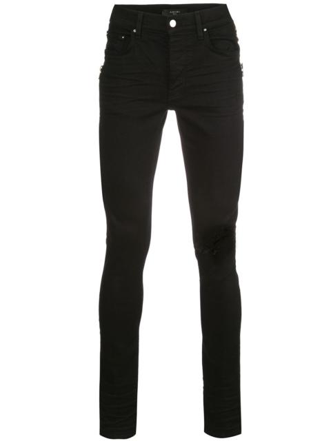 AMIRI mid rise distressed skinny jeans