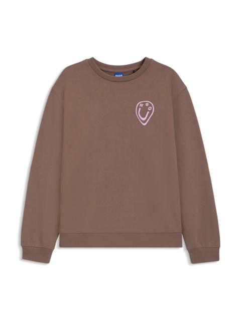 HUGO ALL-GENDER SWEATSHIRT WITH HAPPY HUGO ARTWORK