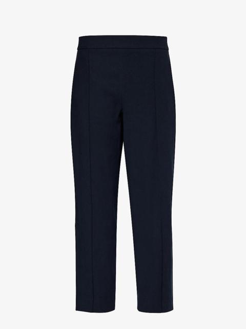 Pinched-seam tapered-leg mid-rise stretch linen-blend trousers