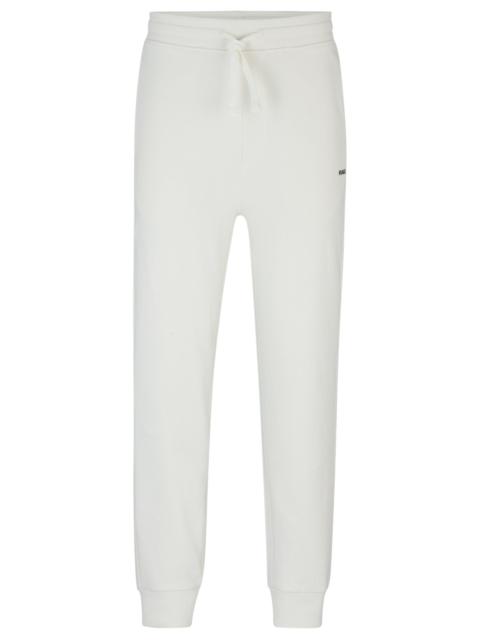 HUGO COTTON-TERRY TRACKSUIT BOTTOMS WITH LOGO PRINT
