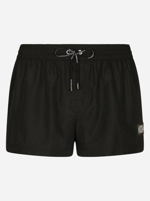Short swim trunks with branded tag