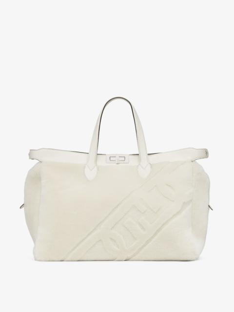FENDI Peekaboo ISeeU Forty8 bag made of soft white sheepskin with an oversized shaved O’Lock motif. Roomy 
