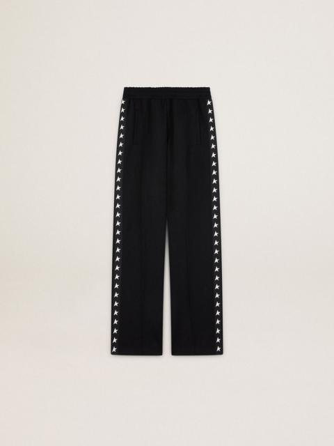 Women’s black joggers with white stars on the sides