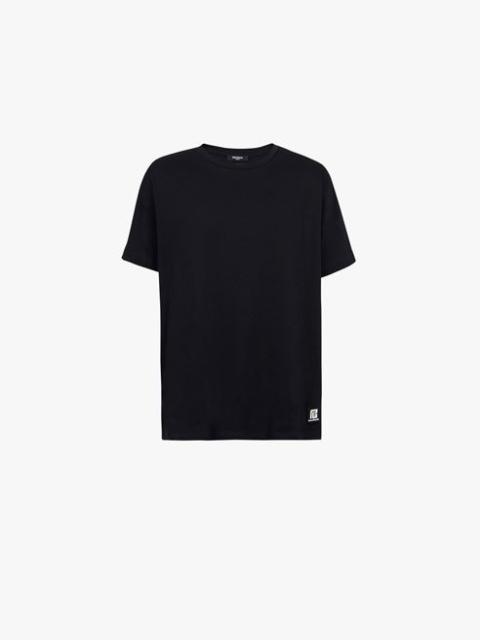 Oversized black eco-designed cotton T-shirt with white Balmain logo print