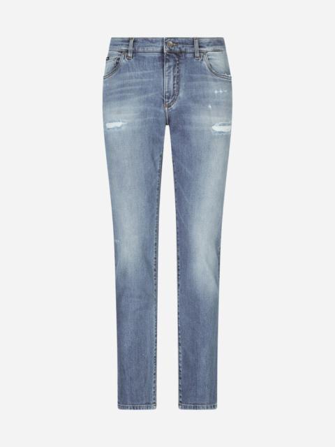 Slim-fit stretch jeans with repaired rips