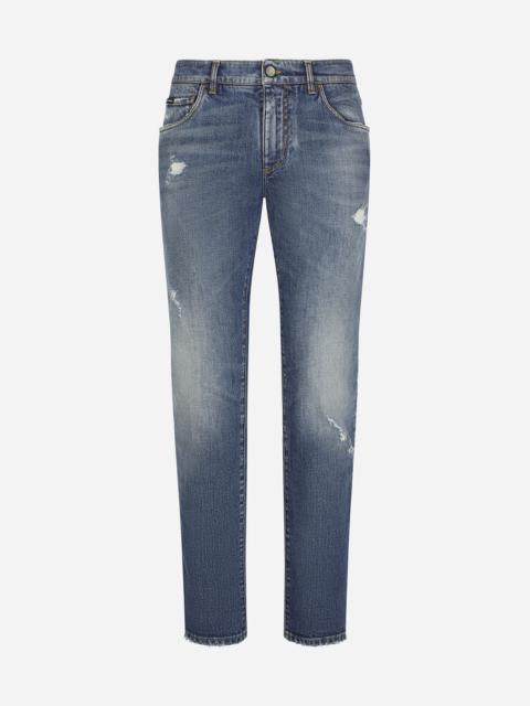 Light blue slim-fit stretch jeans with abrasions