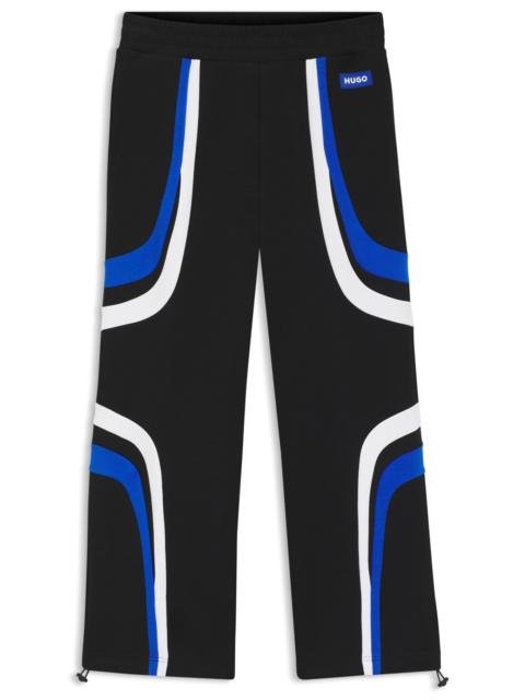 HUGO STRETCH-COTTON TRACKSUIT BOTTOMS WITH COLOURFUL PANELLING