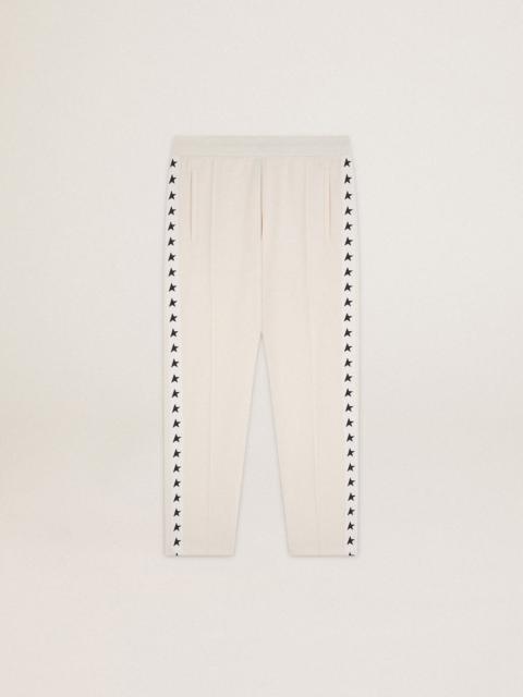 Men's white joggers with black stars on the sides
