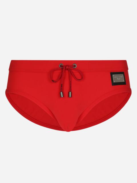 Swim briefs with high-cut leg and branded tag