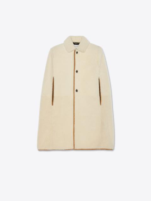 SAINT LAURENT buttoned cape in shearling