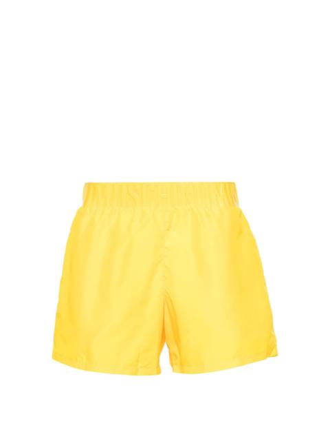 Moschino logo-embossed swim shorts