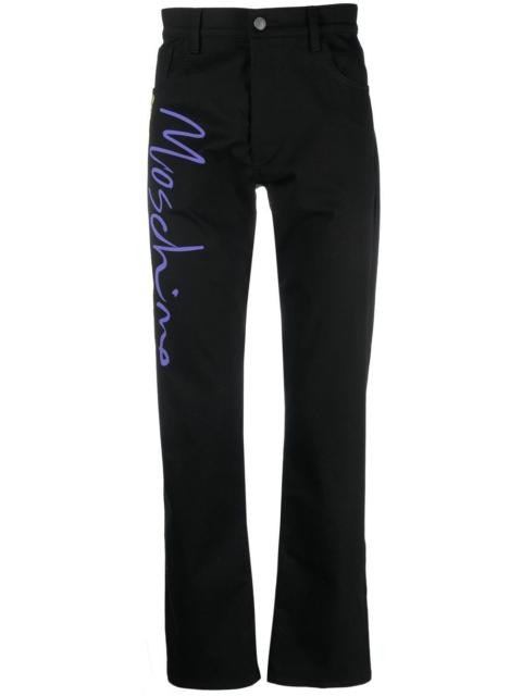 Moschino tailored logo-print trousers