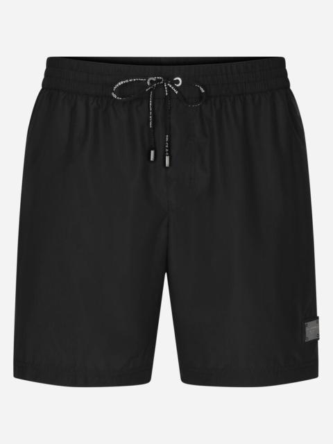Mid-length swim trunks with branded plate