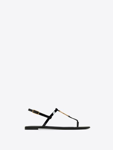 SAINT LAURENT cassandra flat sandals in patent leather with gold-tone monogram