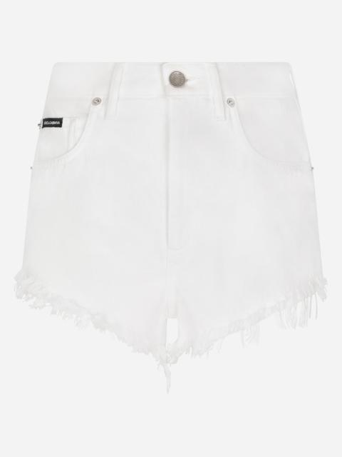 Denim shorts with ripped details and abrasions