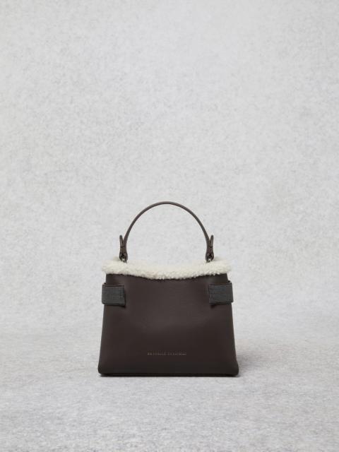 Brunello Cucinelli Matte calfskin bag with shearling trim and precious bands