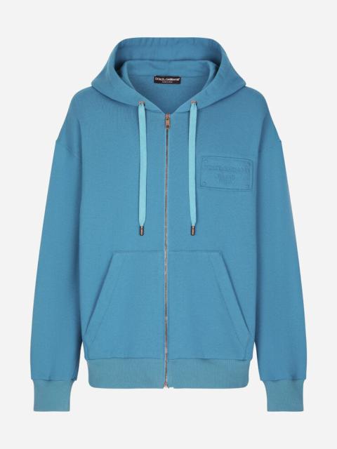 Zip-up hoodie with embossed tag