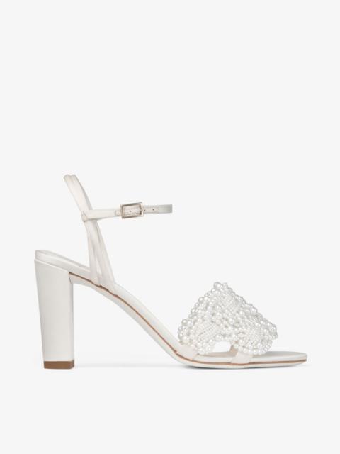 JIMMY CHOO Cary 85
Ivory Satin Block Heel Sandal with Pearl Embellishments