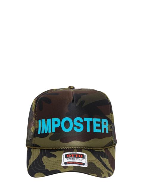 ASHLEY WILLIAMS Camo Imposter Trucker Hat