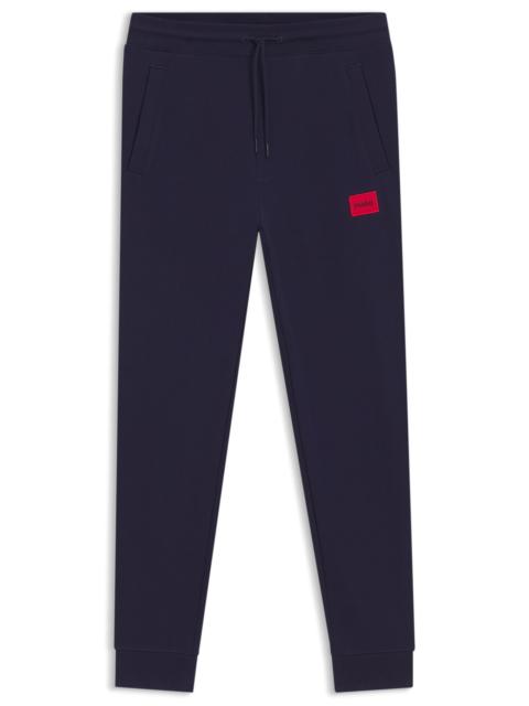 HUGO COTTON-TERRY TRACKSUIT BOTTOMS WITH LOGO LABEL