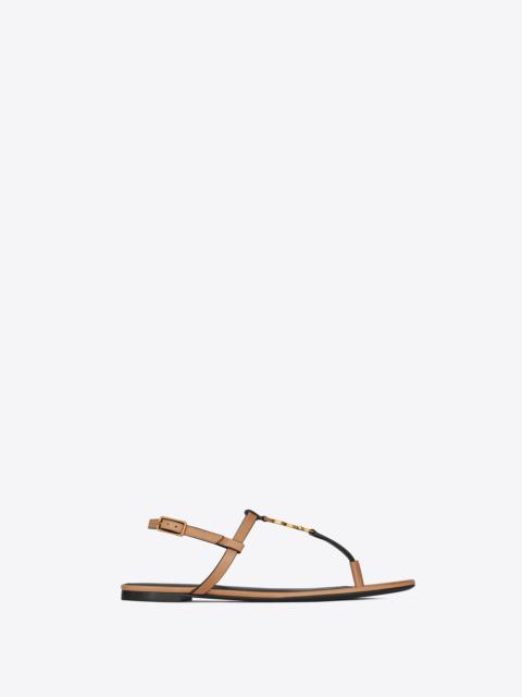 SAINT LAURENT cassandra flat sandals in vegetable-tanned leather with bronze-tone monogram