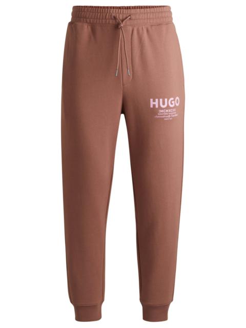 HUGO COTTON-TERRY TRACKSUIT BOTTOMS WITH LOGO PRINT