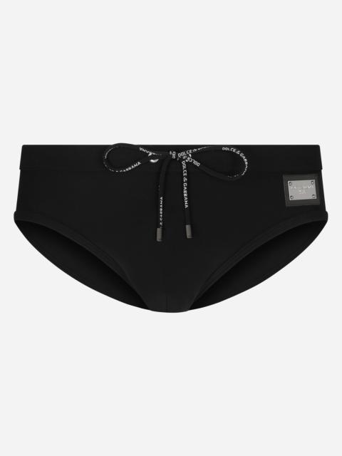 Swim briefs with high-cut leg and branded tag
