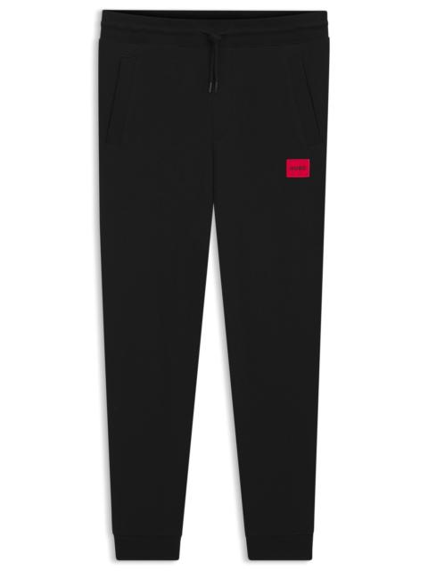 HUGO COTTON-TERRY TRACKSUIT BOTTOMS WITH RED LOGO LABEL