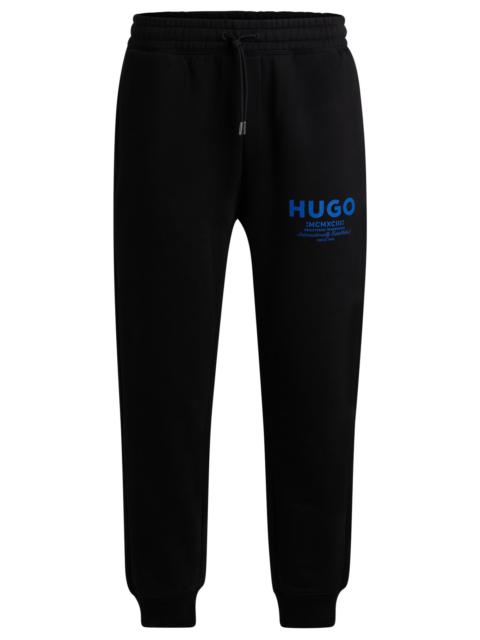 HUGO COTTON-TERRY TRACKSUIT BOTTOMS WITH LOGO PRINT