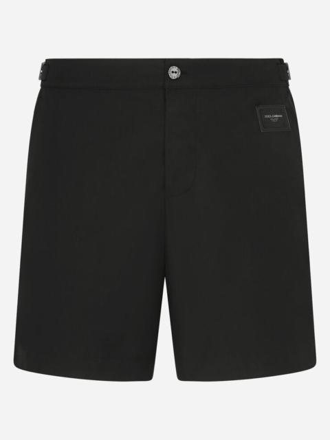 Mid-length swim shorts with branded plate