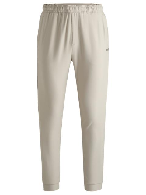 BOSS TRACKSUIT BOTTOMS IN STRETCH FABRIC WITH DECORATIVE REFLECTIVE LOGO