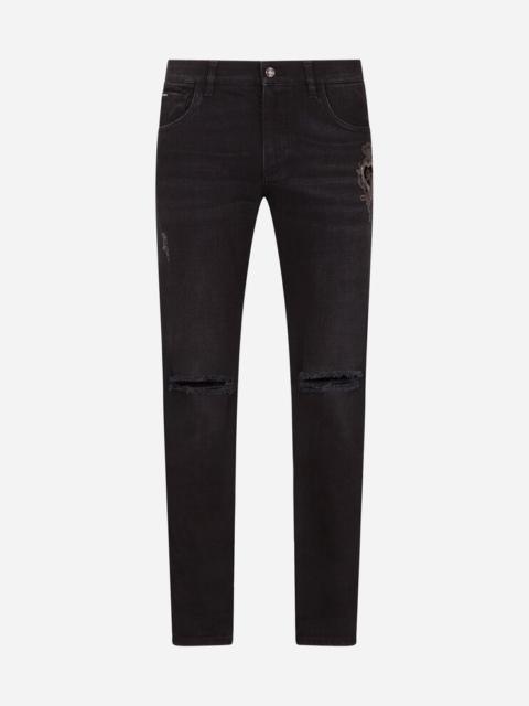 Dolce & Gabbana Washed black slim-fit stretch jeans with patch detailing