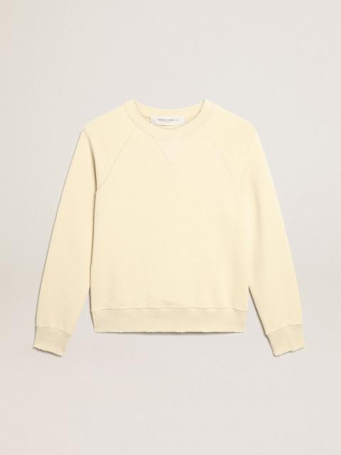 Marzipan-colored sweatshirt with lettering on the back