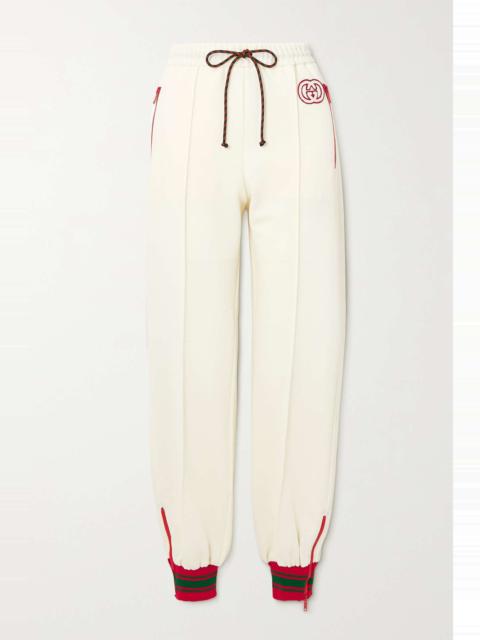 GUCCI Striped appliquéd stretch-jersey tapered track pants